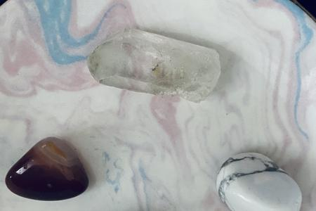 Crystals and gemstones on a marbled surface